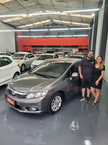Cliente da Ultra Veículos com o carro que comprou na loja