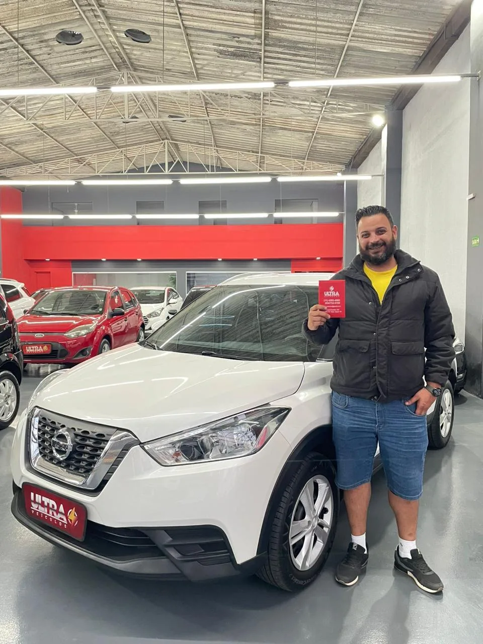 Cliente da Ultra Veículos com o carro que comprou na loja