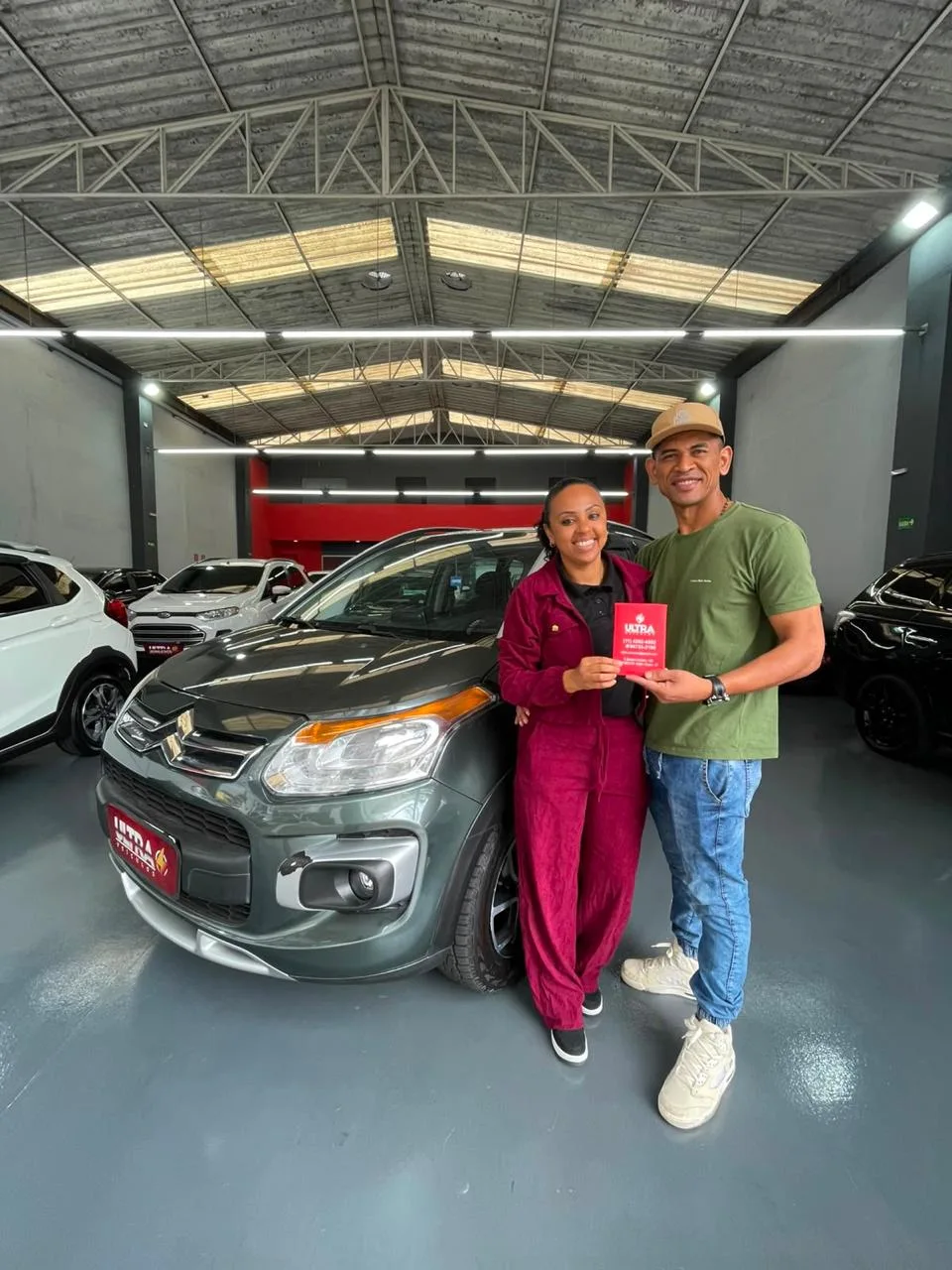 Cliente da Ultra Veículos com o carro que comprou na loja